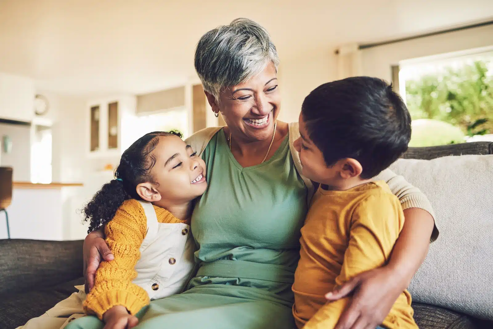 happy grandmother hugs her grandchildren